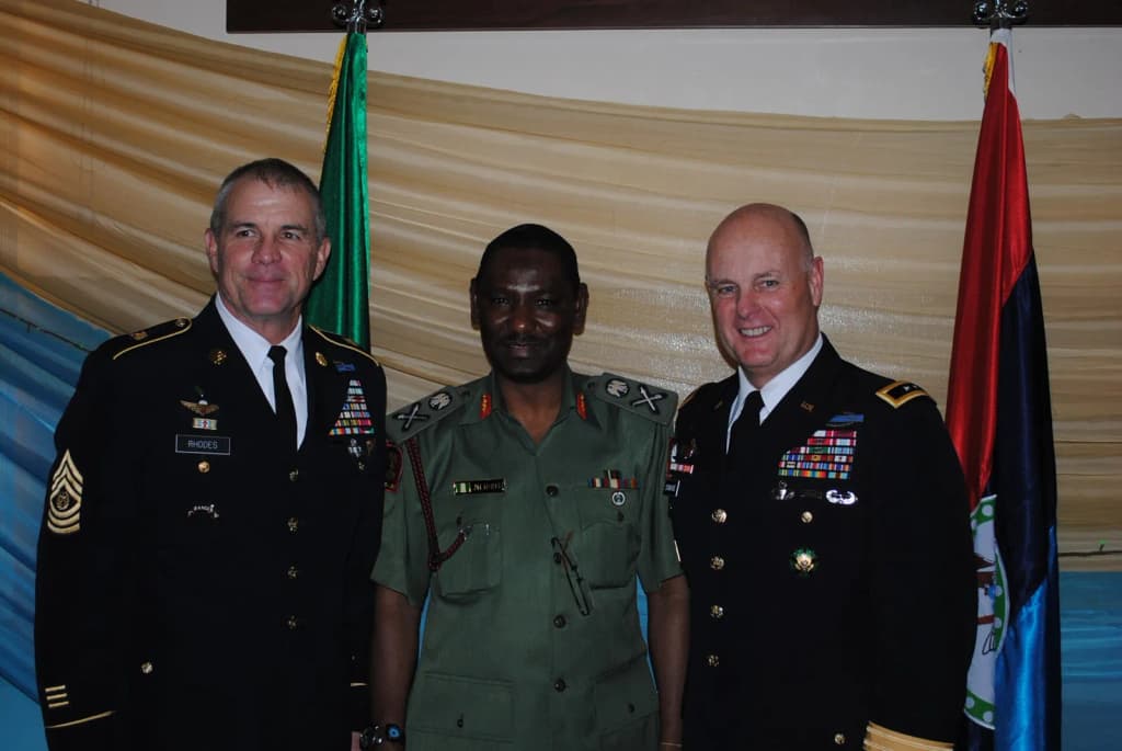 Maj. Gen. Patrick J. Donahue, commander, U.S. Army Africa (right), and Command Sgt. Maj. Hu Rhodes, USARAF command sergeant major (left) pose with Maj. Gen. Muh