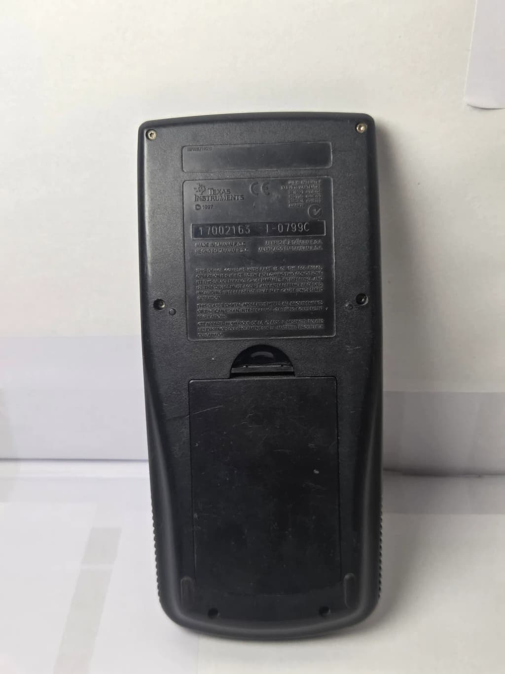 Rear view (slide cover) of a Texas Instruments TI-89 Graphing Calculator (with slide cover, 1997 model).
