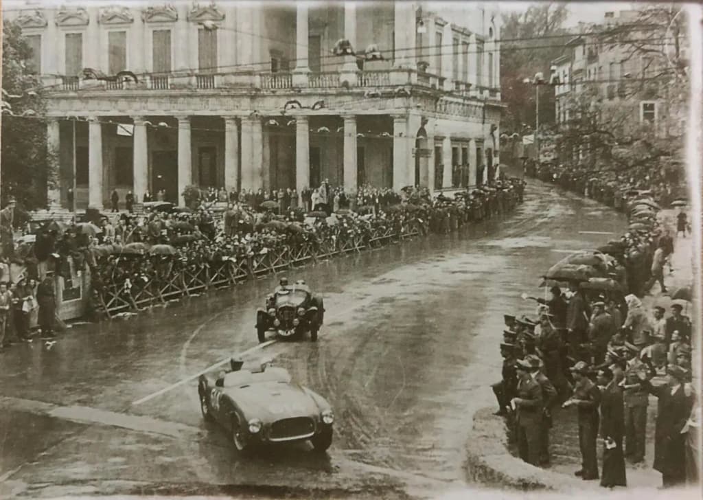 The 1952 Ferrari 340 America Vignale Spyder s/n 0196A (driven by Taruffi) in front, and Delahaye 135 MS behind, in Vicenza during Mille Miglia on 3 May 1952.