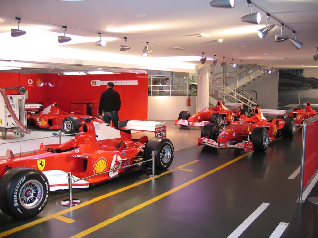 A collection of Ferrari Formula One racing cars from the Michael Schumacher -era at the Ferrari Museum in Maranello , Italy .