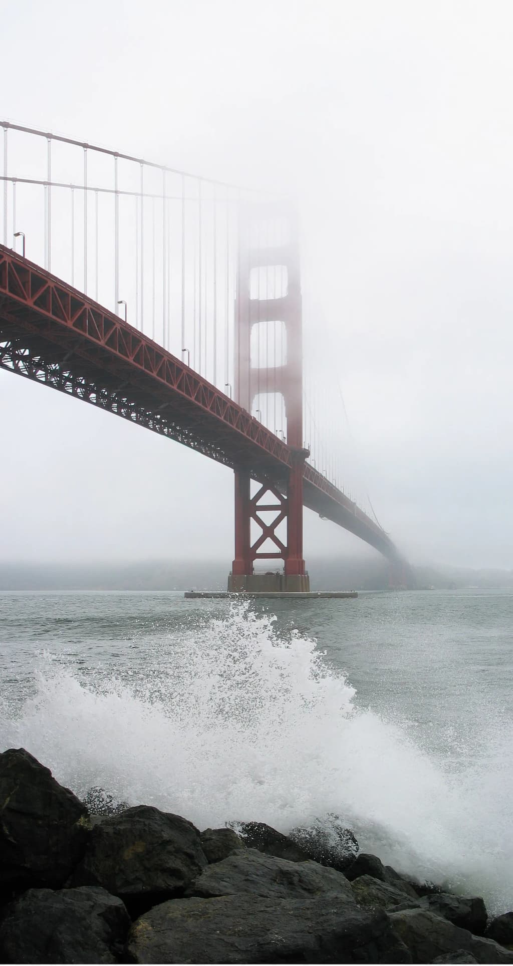 The Golden Gate Bridge as seen from Fort Point on a foggy day.