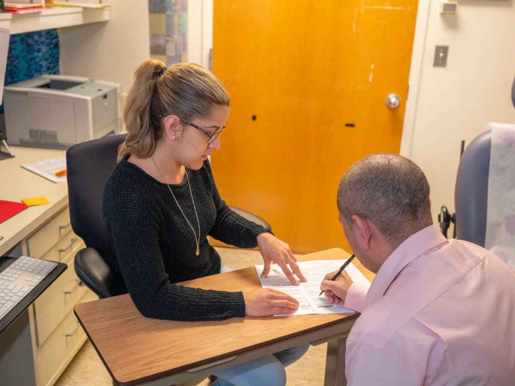 NIAID clinical trial volunteer signs an informed consent form, acknowledging that he understands the study protocol as well as possible risks and benefits assoc
