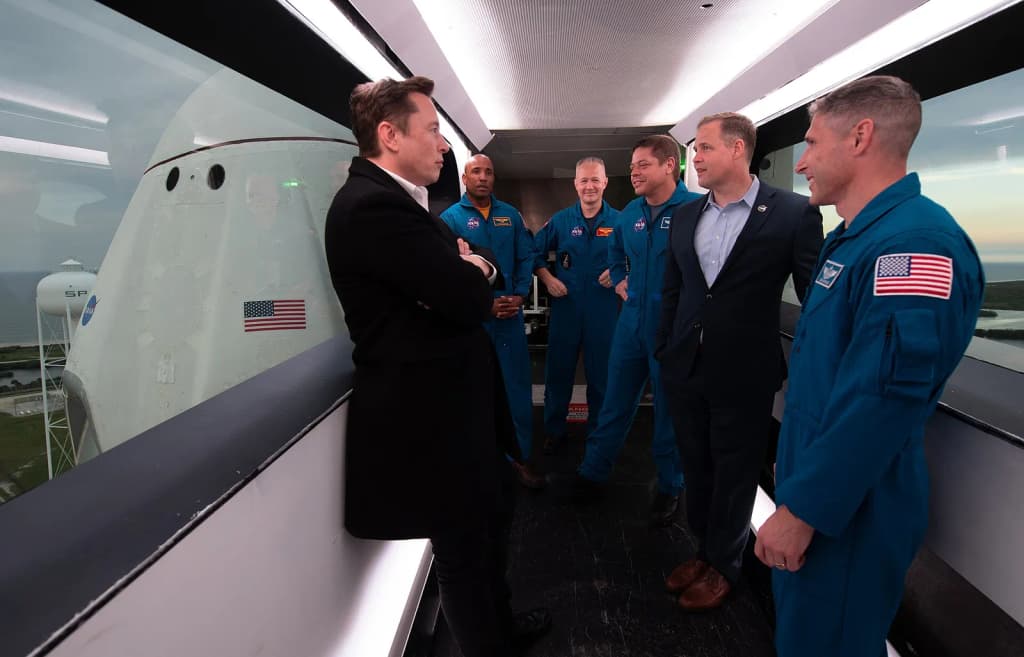 SpaceX CEO and Chief Designer Elon Musk, left, NASA astronauts Victor Glover, Doug Hurley, Bob Behnken, NASA Administrator Jim Bridenstine, and NASA astronaut M