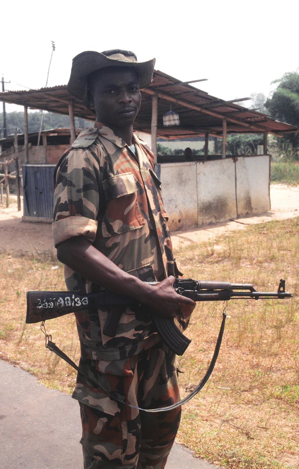 Nigerian Army soldier, part of the Economic Community Military Observation Group (ECOMOG), mans one of the six security checkpoints on the 36 mile road leading