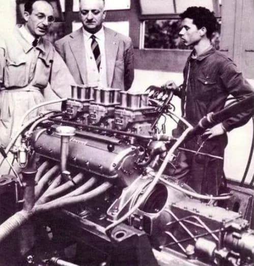 This engine looks a lot like the Colombo-designed new V12 that sat in the 1947 Ferrari 125 S. Enzo Ferrari in the middle. Two unknown engineers. Or, the left on