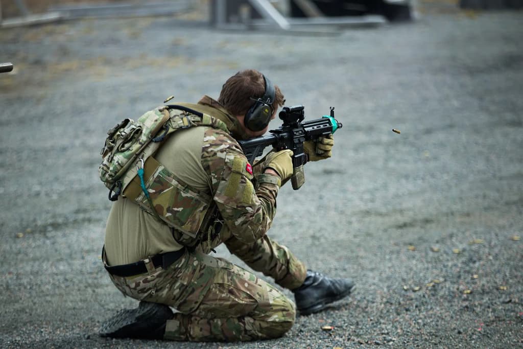 A Norwegian Coastal Ranger Commando (KJK) fires downrange amid an immediate action drill during exercise Platinum Ren at Fort Trondennes, Harstad, Norway, May 1