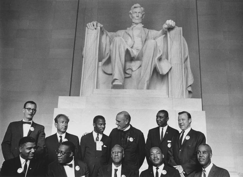 Scope and content: Pictured are: (standing L-R) director of the National Catholic Conference for Interracial Justice Matthew Ahmann, Rabbi Joachim Prinz, Student Nonviolent Coordinating Committee (SNCC) leader John Lewis, Protestant minister Eugene Carson Blake, Congress of Racial Equality (CORE) leader Floyd McKissick, and labor union leader Walter Reuther; (sitting L-R) National Urban League executive director Whitney Young, chairman of the Demonstration Committee Cleveland Robinson, labor union leader A. Philip Randolph, Dr. Reverend Martin Luther King Jr., and National Association for the Advancement of Colored People (NAACP) leader Roy Wilkins