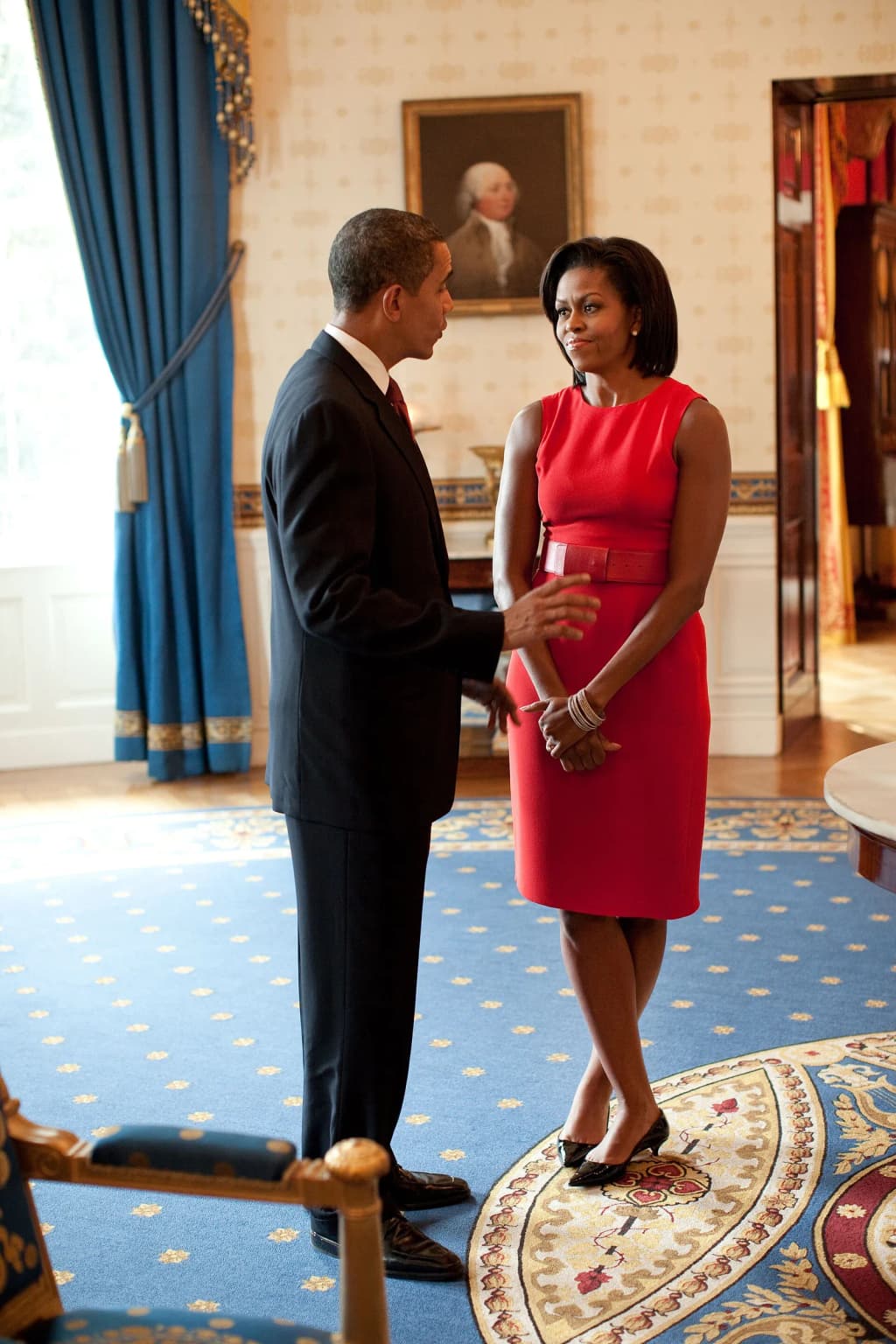 President Barack Obama and First Lady Michelle Obama talk in the Blue Room of the White House before the start of the Presidential Medal of Freedom ceremony on