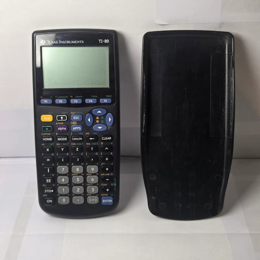 Front view (with slide cover) of a Texas Instruments TI-89 Graphing Calculator (with slide cover, 1997 model).