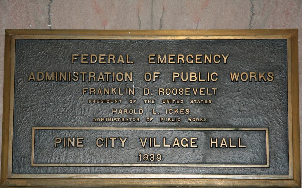 "Federal Emergency Administration of Public Works / Franklin D. Roosevelt / President of the United States / Harold L. Ickes / Administrator of Public Works / Pine City Village Hall / 1939" A plaque on an interior wall of the Pine City Village Hall, Pine County, Minnesota