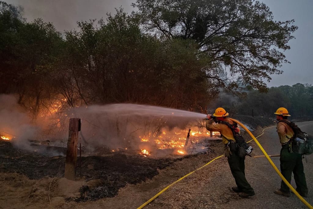 Sequoia Engine 45 cools off the edge of the burnout that the Springville Hotshots had just completed down a dozer line to Road 81 just north of the Mammoth Pools Trailer Park on the evening of September 10, 2020 as efforts continue to contain the Creek Fire on the Sierra National Forest.