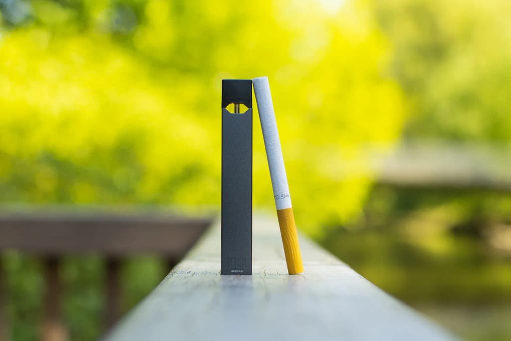 JUUL Labs Inc. vape used in a lifestyle scenario next to cigarette comparison. Free to use when crediting to <a href=" https://vaping360.com/best-vape-starte